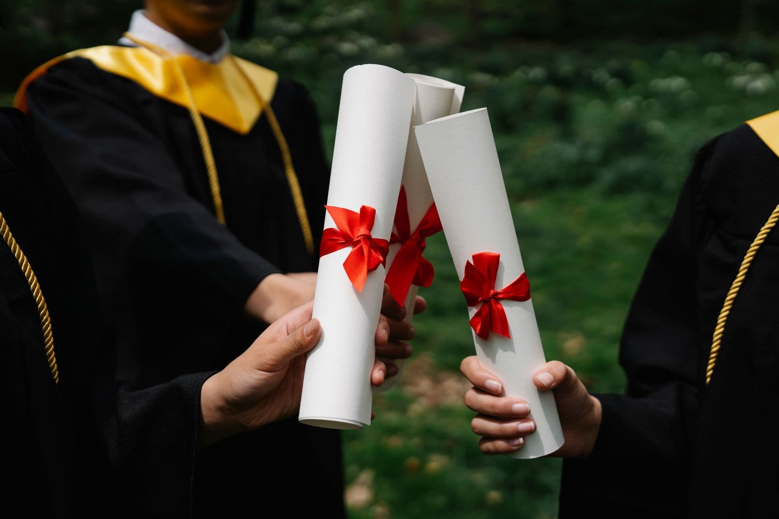 Graduates holding diplomas during a commencement ceremony
