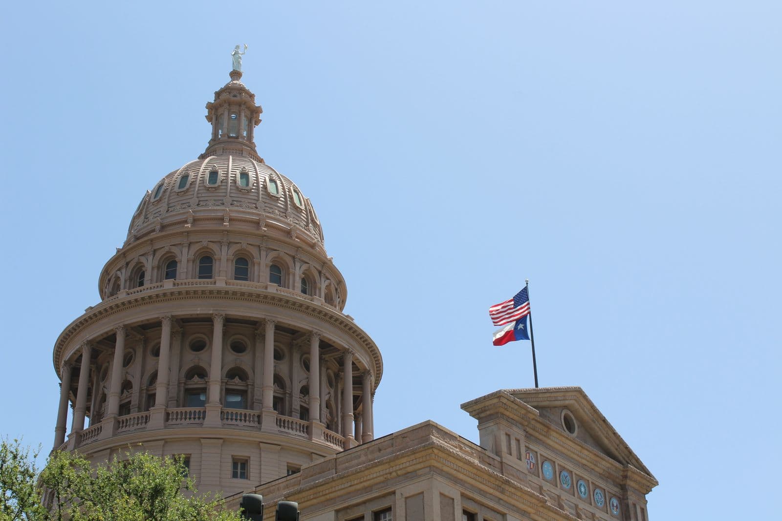 The Texas State Capitol dome and flags in Austin, Texas